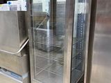 stainless steel refrigerators and freezers in a warehouse area
