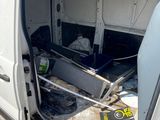 a white van that has been vandalized and is in the process of being repaired