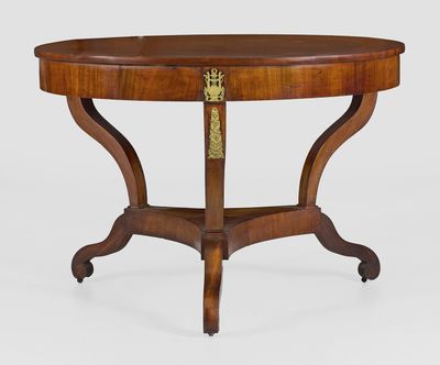 a round table with a wooden top and a brass plate on the top