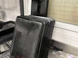a stack of pans sitting on the floor in a kitchen