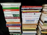 a lot of books stacked on top of each other