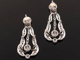 a pair of diamond and silver earrings