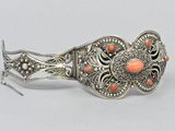silver bracelet with coral stones and filigree accents