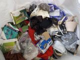 a white bag filled with assorted items on a table