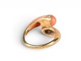 an image of a gold ring with an orange stone in it