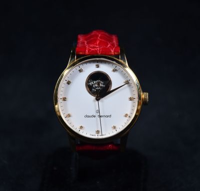 an image of a close up of a wrist watch on a black surface