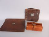 two pieces of brown leather on a white surface