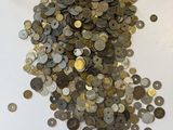 a pile of coins sitting on a white surface