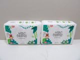 two boxes of baby diapers sitting on top of a table