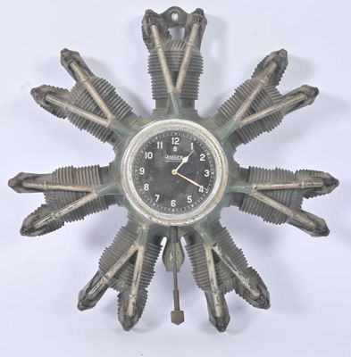 a clock made out of old motorcycle parts on a white surface