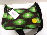 a green and brown bag with a smiley face on it