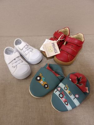 three pairs of shoes that are on the floor next to each other
