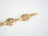 gold plated key chain with two keys on a white background