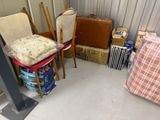a room with a chair, suitcase, and other items in it