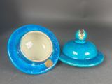 pair of blue and white ceramic dishes with lids on a gray surface