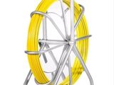 a close up of a roll of yellow wire on a metal stand