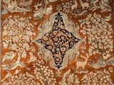 an orange and white rug with a floral design on it