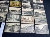 many pictures of old buildings on display on a table
