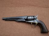 an old revolver with a wooden handle on a brown background