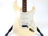 fender stratocator electric guitar on stand against a white background