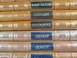 several books stacked on top of each other with names on them