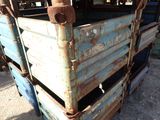 an old blue truck with rust on the back