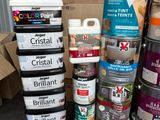 many cans of paint stacked on top of each other