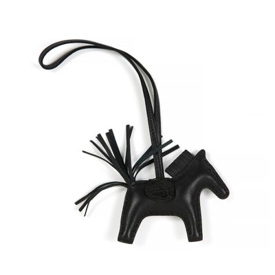 black leather horse ornament with tassels hanging from it ' s neck