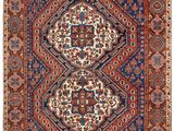 tapis persan ancien à motifs bleus et rouges