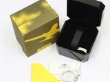 a box with a watch inside of it on a white surface