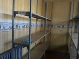 a room with shelves and a radiator in it