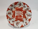 a red and white plate with a picture on it