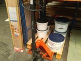 a fork lifter with buckets on it in a warehouse