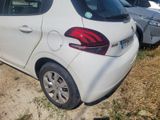 a small white car parked in a lot with other cars