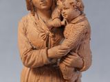 figurine of a woman holding a child in her arms