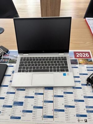 a laptop computer sitting on top of a calendar