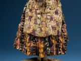 statue of a woman in a dress made out of shells