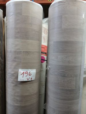 several rolls of fabric sitting on top of a shelf in a store
