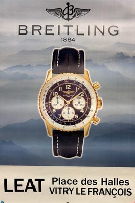 a poster for a watch that is on the wall