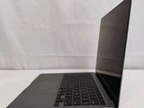 an open laptop computer sitting on top of a white table