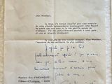 an old piece of paper with a handwritten letter on it sitting on a table