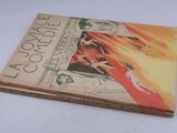 an old book with a picture of a woman in a red dress on it