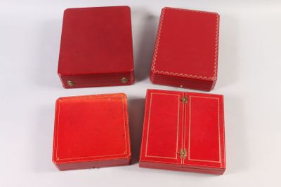 three small red boxes are sitting next to each other on a white surface