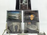 three star wars action figures sit on top of a stack of boxes
