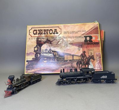 un circuit de train miniature et une boîte de jeux posés sur la table
