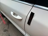 a white car with a sticker on the side of it