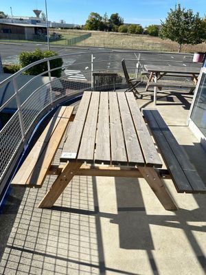 a wooden picnic table on the roof of a building