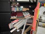 a pile of clothes on a desk in a room