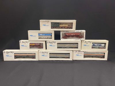 six boxed boxes of model trains sitting on a black surface