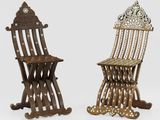 pair of antique wooden chairs with ornate carvings on them